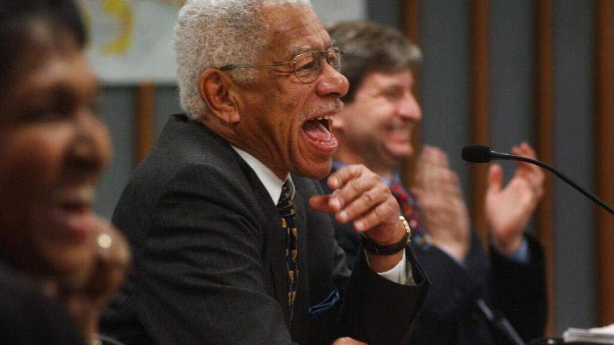 Harold Webb, center, laughs at a remark made by Vernon Malone after Webb’s swearing in as a member of the Wake County Board of Commissioners in 2003. Webb died Thursday, Dec. 14, 2017.