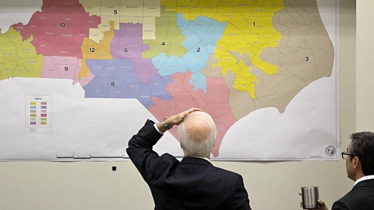 Joint Select Committee on Congressional Redistricting members review historical voting maps lining the walls during their morning meeting at the N.C. Legislature in February.