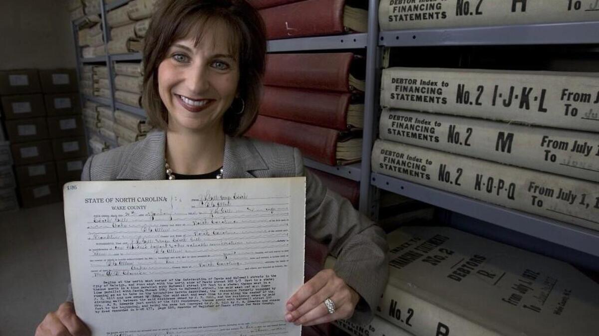Wake County Register of Deeds Laura Riddick holds page 126 from book 286 from 1914. It is the deed to the building that houses the 7,000 volumes of books in the deeds office in the Garland Jones Office Building in downtown Raleigh. It, and all of the others, are now available online.