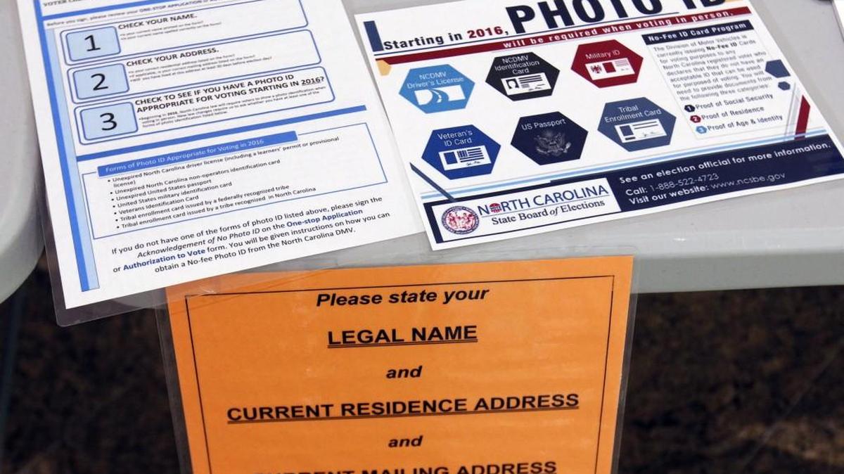 Detail photo of information placards on the welcoming voters' table in the lobby of the Paul Green Theatre on the UNC-CH during the March 2016 primary.