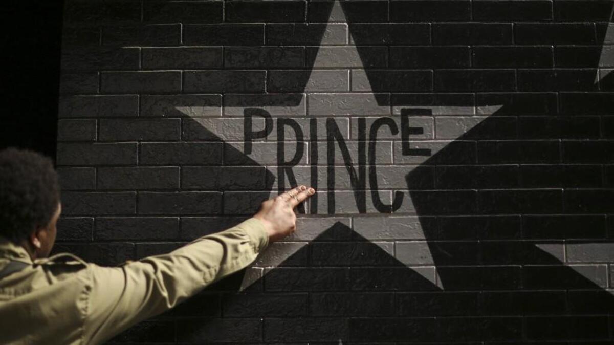 After kissing his fingers, a fan touches Prince's star on the wall of First Avenue in Minneapolis on Thursday. (Jeff Wheeler/Minneapolis Star Tribune/TNS)