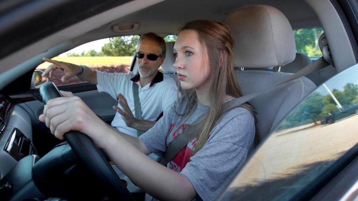 
Jordan Driving School instructor Robert Escamilla talks with student driver Courtney Barron, a rising sophomore at Cary High School in June.
