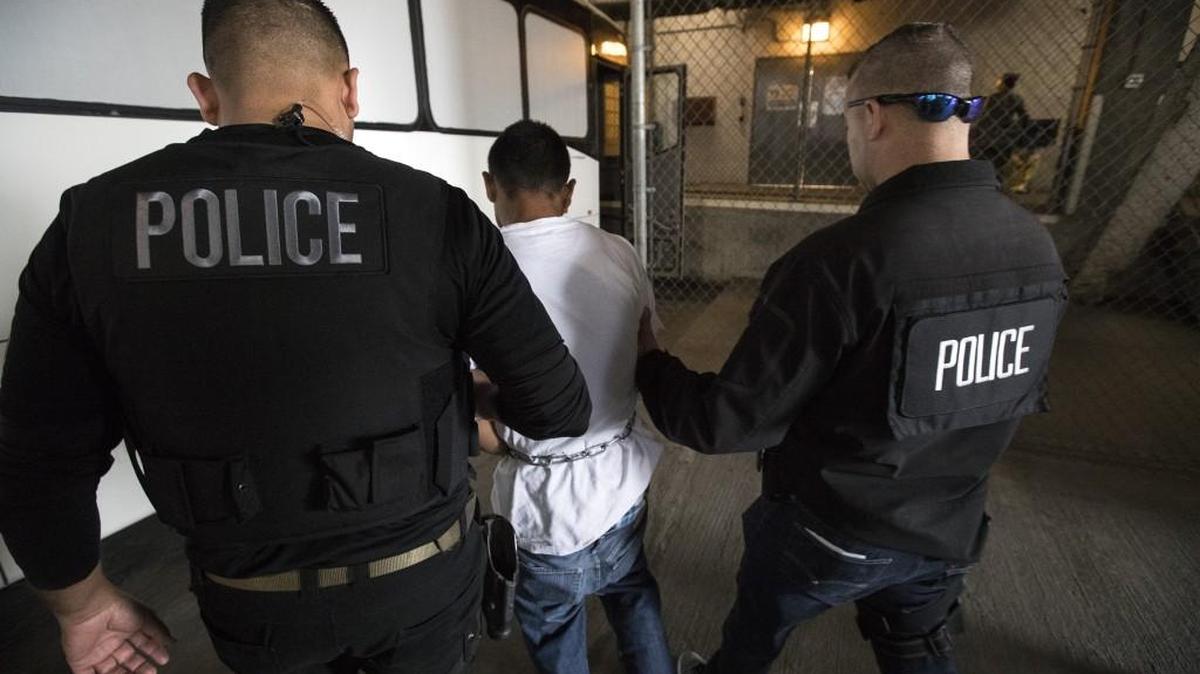 Juan Vega, middle, is escorted by agents into the Immigration and Customs Enforcement downtown staging facility in Los Angeles on April 18, 2017.