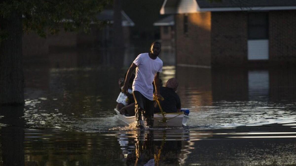 Residents return from checking on their homes after Hurricane Matthew caused downed trees, power outages, a municipal water outage and widespread flooding along the Lumber River Oct. 13 in Lumberton.