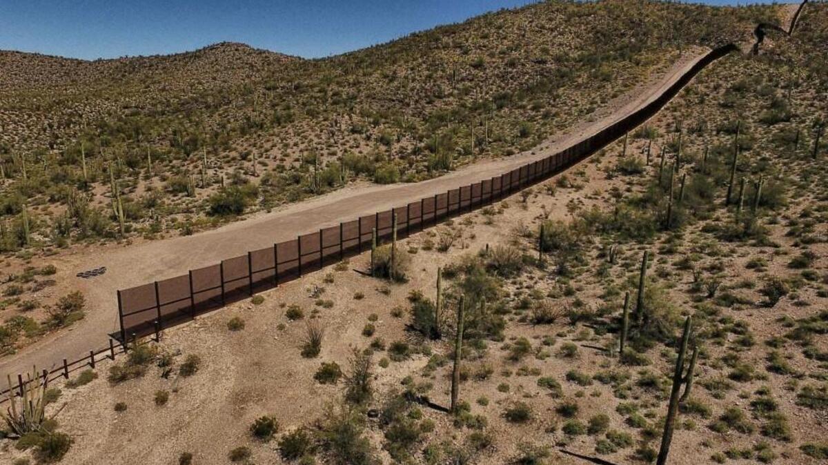 View of the metal fence along the border in Sonoyta, Sonora state, northern Mexico, between the Altar desert in Mexico and the Arizona desert in the United States, on March 27, 2017. 