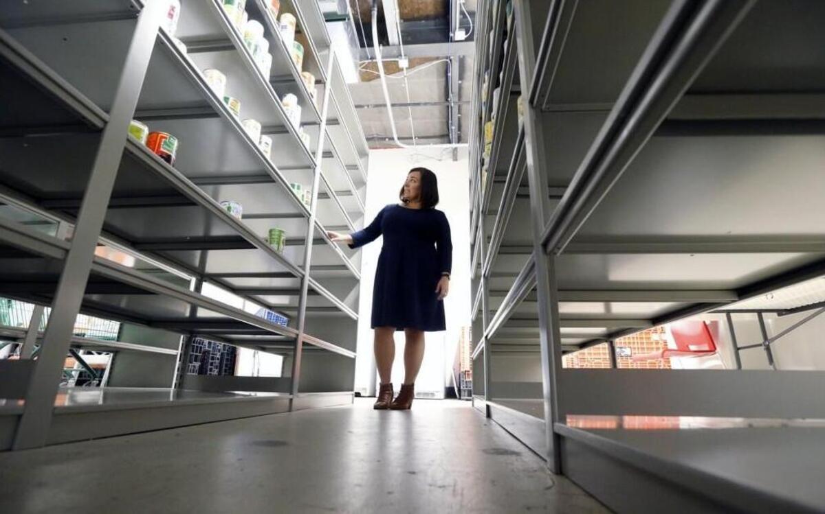 Lizzy Adams with Salvation Army communications department looks over the depleted shelves in the organization's food pantry in their building on Capital Blvd. in Raleigh on Nov. 29, 2016. "Normally, these would be much fuller this time of year," with people donating in the holiday spirit, she said. But this year the Salvation Army assisted other organizations helping victims of Hurricane Matthew, taking a toll on their own supply of food that they distribute to needy families.