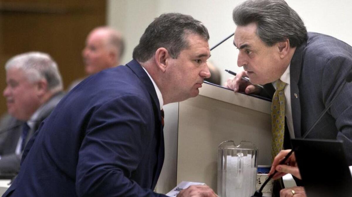 Republican Cochairs Representative David Lewis, left, and Senator Bob Rucho huddle during the Joint Select Committee on Congressional Redistricting's meeting at the General Assembly on Feb. 16.