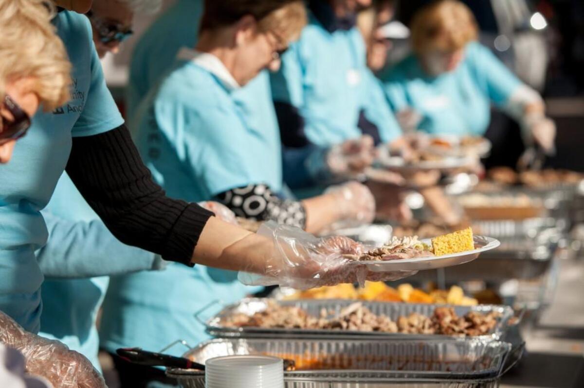 Volunteers serve food during Sunday Supper on Fayetteville Street.