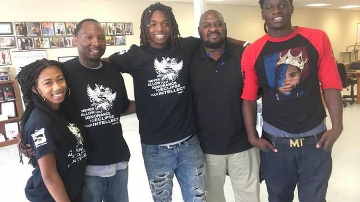From left to right, Teresa P., Sean Ingram, Zayvion W., Eric Andrews and Stephon B. pose for picture at the Sean Ingram Academy in Raleigh on July 5, 2017. Teresa, Zayvion and Stephon attended the Wake County Teen Diversion Program run by Andrews.