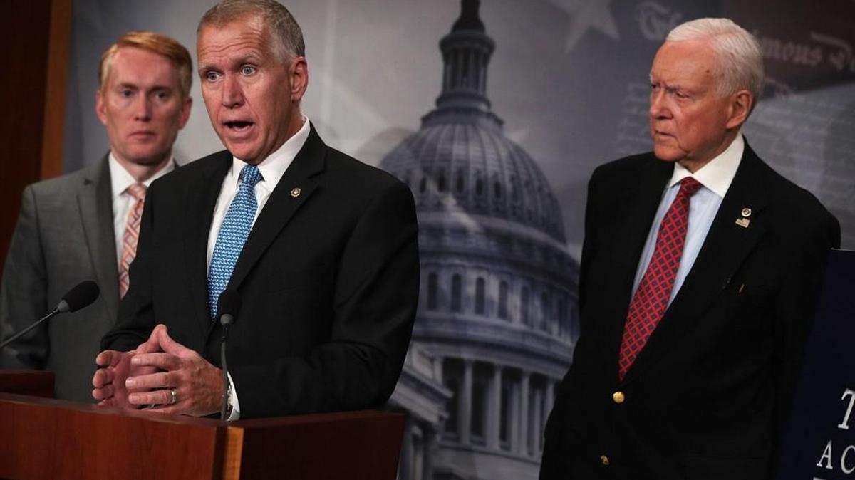 U.S. Sen. Thom Tillis (R-NC) (2nd L) speaks as Sen. James Lankford (R-OK) (L) and Sen. Orrin Hatch (R-UT) (R) listen during a news conference announce the “SUCCEED Act” September 25 at the Capitol in Washington, DC. Tillis is also advocating federal tax cuts that follow the North Carolina model that passed in 2013 when he served as the state’s House speaker.