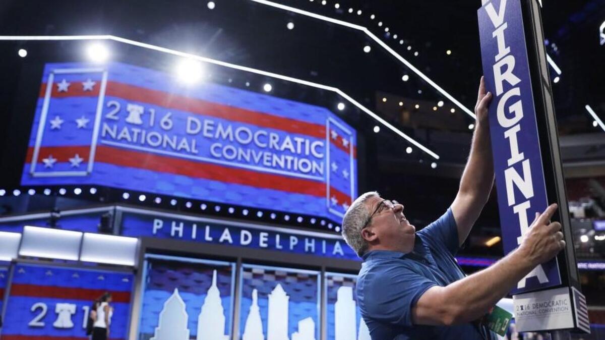 Jimmy Wright installs the Virginia delegation placard ahead of the 2016 Democratic National Convention in Philadelphia, Sunday, July 24, 2016. (AP Photo/Matt Rourke)