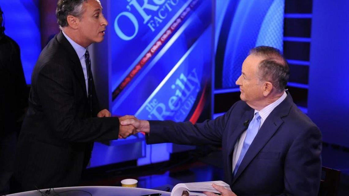 In this Sept. 22, 2010 file photo, Jon Stewart, from Comedy Central’s “ “The Daily Show with Jon Stewart,” left, shakes hands with Bill O’Reilly during the taping of a segment on “The O’Reilly Factor,” on the FOX News Channel, in New York.
