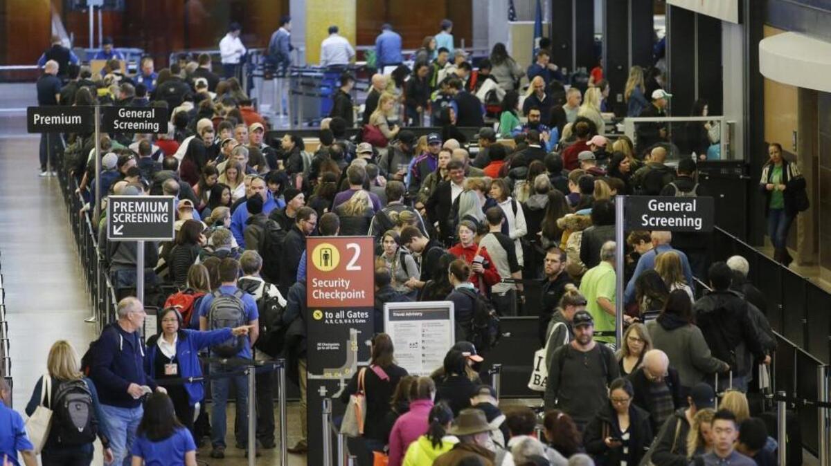 In this March 17, 2016, photo, travelers wait in line for security screening at Seattle-Tacoma International Airport in Seattle. Fliers will likely face massive security lines at airports across the country this summer, with airlines already warning passengers to arrive at least two hours early or risk missing their flight. (AP Photo/Ted S. Warren)