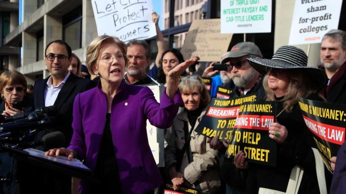 Sen. Elizabeth Warren, D-Mass., speaks at a rally outside the Consumer Financial Protection Bureau headquarters in Washington, Tuesday, Nov. 28, 2017. The group was protesting President Donald Trump's appointment of Mick Mulvaney as Consumer Financial Protection Bureau's acting director.
