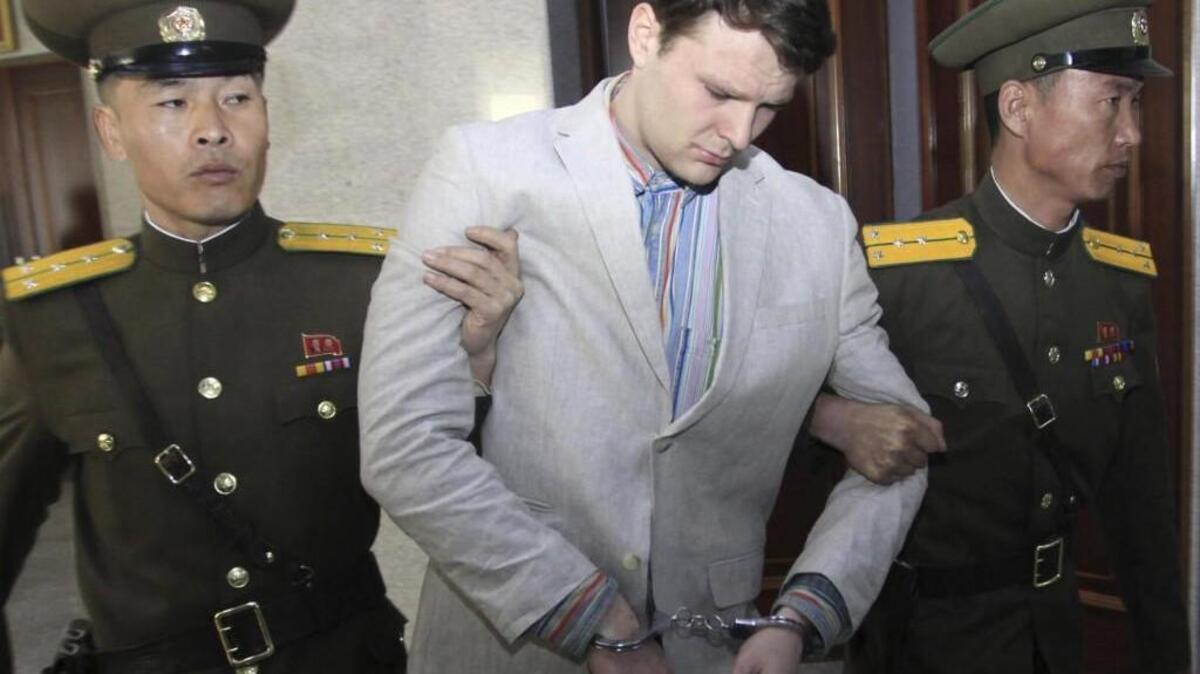 In this March 16, 2016 photo, American student Otto Warmbier, center, is escorted at the Supreme Court in Pyongyang, North Korea. The death last week of American student Warmbier, who fell into a coma after being arrested in North Korea, has led to increased calls for the release of other Americans being held by North Korea. questions about whether his tour agency was adequately prepared for its trips into the hard-line communist state. The Young Pioneer Tours agency built up a business attracting young travelers with cut-rate, hard-partying adventures into one of the worldâ€™s most isolated countries. (AP Photo/Jon Chol Jin, File)