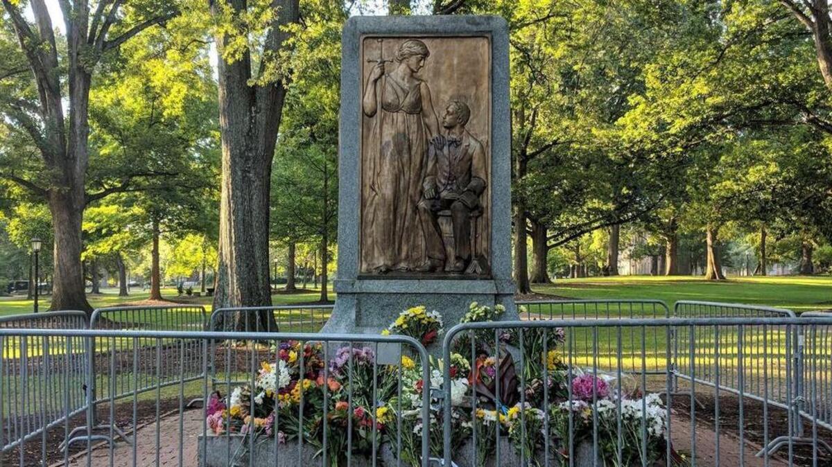 Local members of the North Carolina Division of the Sons of Confederate Veterans placed flowers Saturday morning on the base that once held the Silent Sam statue at UNC-Chapel Hill. The statue was toppled on Aug. 20.