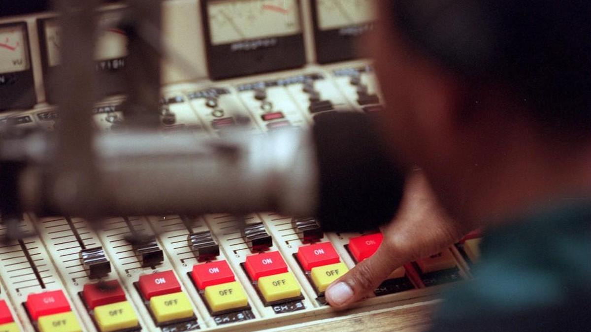 Bob Robinson works the controls of WSHA at Shaw University in Raleigh.