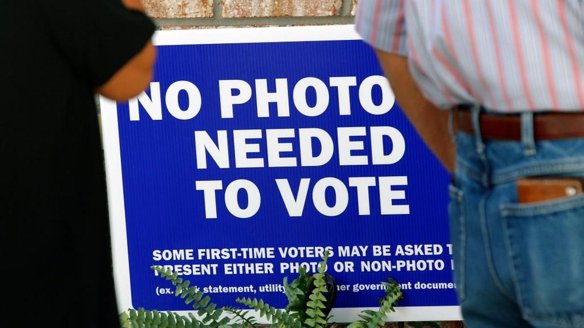 A sign tells voters a photo ID is not required as hundreds come out on the first day of early voting at the Hope Mills Recreation Center in Hope Mills, NC on Oct. 20, 2016. A voter ID bill is again up for debate in North Carolina.