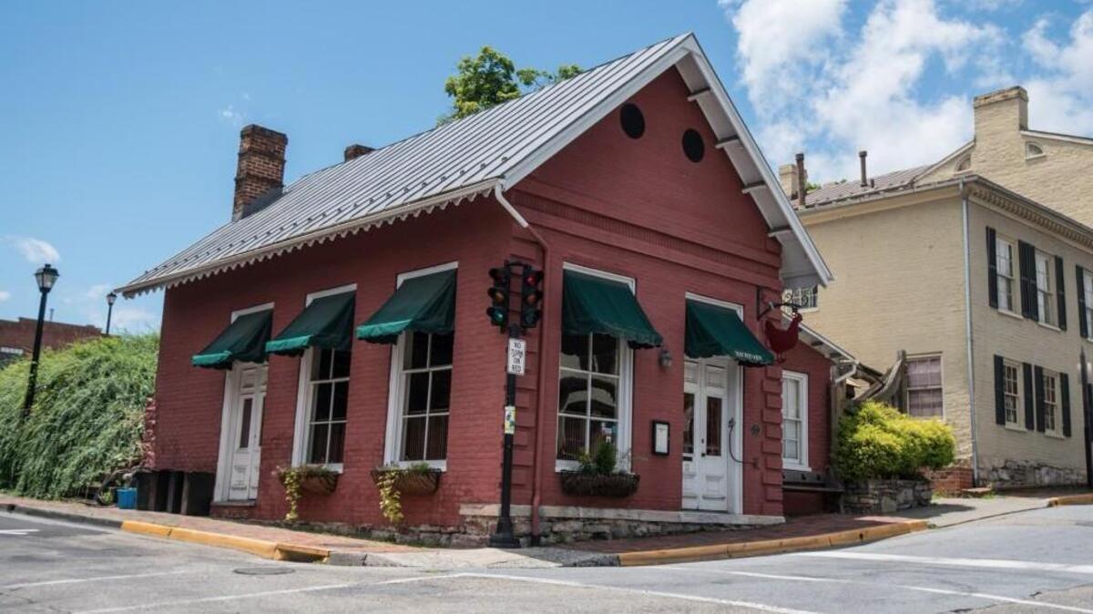 This Saturday, June 23, 2018 photo shows the Red Hen Restaurant in downtown Lexington, Va. White House press secretary Sarah Huckabee Sanders said Saturday in a tweet that she was booted from the Virginia restaurant because she works for President Donald Trump. Sanders said she was told by the owner of The Red Hen  that she had to "leave because I work for @POTUS and I politely left."  (AP Photo/Daniel Lin)
