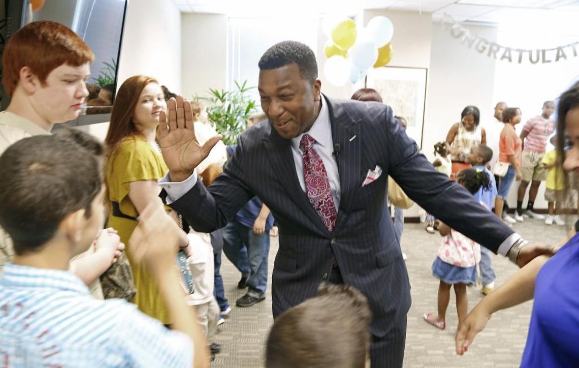 Darrell Allison, center, president of Parents for Educational Freedom in North Carolina greets families and supporters as they celebrate the news that they will be able to stay in private schools now that the N.C. Supreme Court has ruled that vouchers are constitutional in Raleigh on Friday, July 24, 2015.