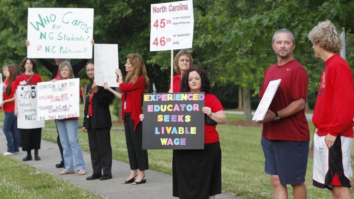 Teachers rally against high turnover and low pay on the sidewalk in front of Apex High School on May 21, 2014. A new report from the National Education Association estimates that North Carolina is ranked 37th in the U.S. in average teacher pay.