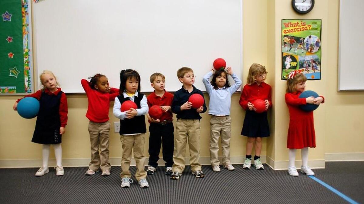 Kindergarteners at Thales Academy in Apex prepare to play ball in their physical education class on Monday, Nov. 30, 2009.