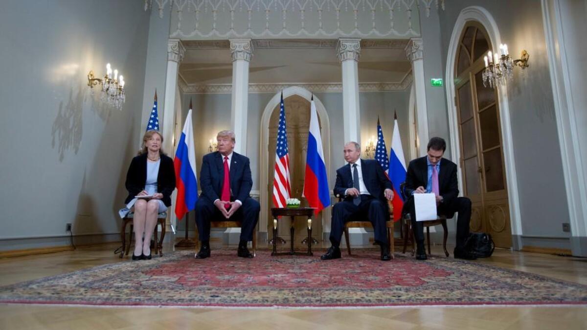 Russian President Vladimir Putin, right, and U.S. President Donald Trump, left, with their interpreters at the beginning of their meeting at the Presidential Palace in Helsinki, Finland, Monday, July 16, 2018. (AP Photo/Pablo Martinez Monsivais)