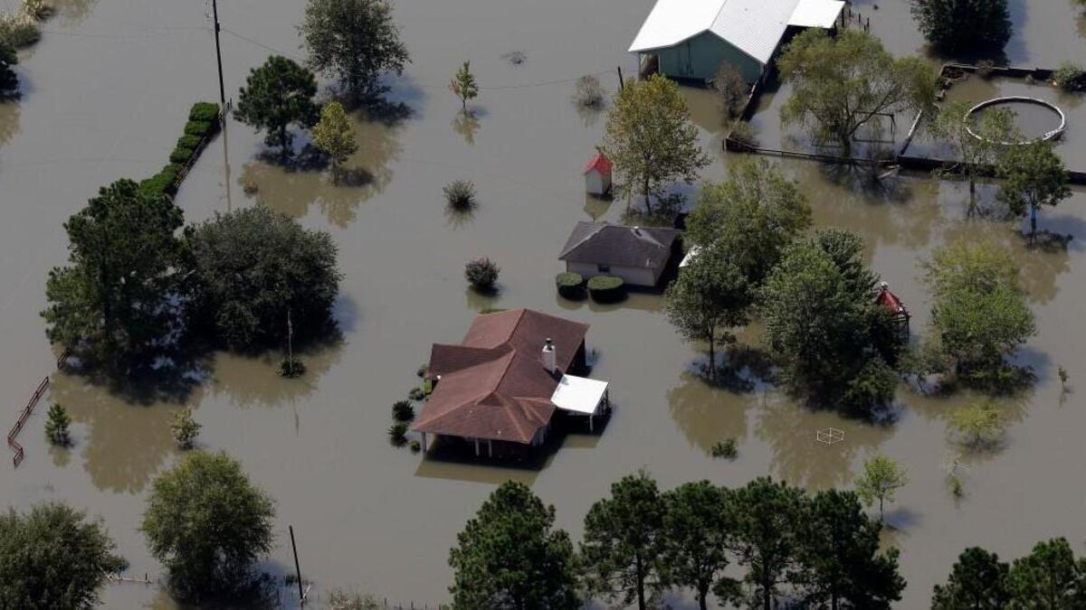 Homes are surrounded by floodwaters in the aftermath of Hurricane Harvey Friday, Sept. 1, 2017, near Beaumont, Texas.