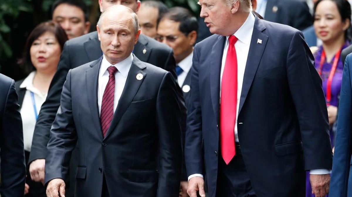 President Donald Trump, right, and Russia's President Vladimir Putin talk during the family photo session at the APEC Summit in Danang, Vietnam in 2017.