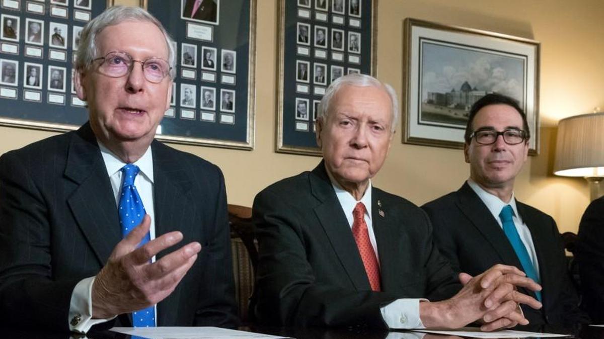 In this Nov. 9, 2017, file photo, from left, Senate Majority Leader Mitch McConnell, R-Ky., Senate Finance Committee Chairman Orrin Hatch, R-Utah, and Treasury Secretary Steven Mnuchin, speak to reporters as work gets underway on the Senate's version of the GOP tax reform bill, on Capitol Hill in Washington.