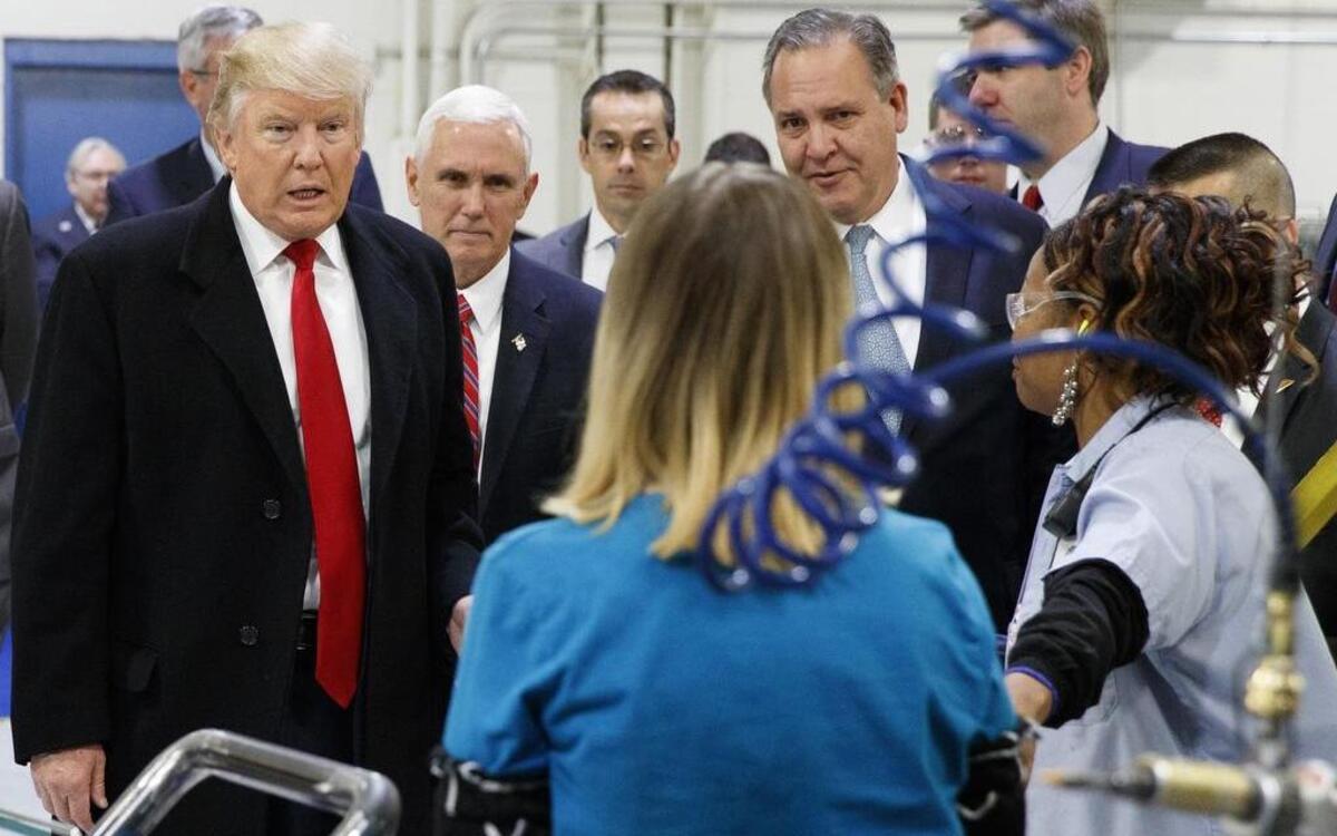 President-elect Donald Trump and Vice President-elect Mike Pence talk to workers during a visit to a Carrier factory on Dec. 1 in Indianapolis, Ind.