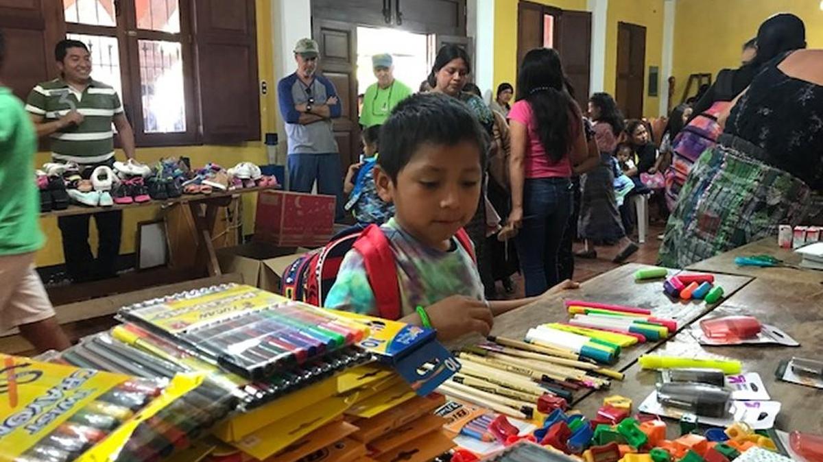 A child looks at school supplies in Guatemala.