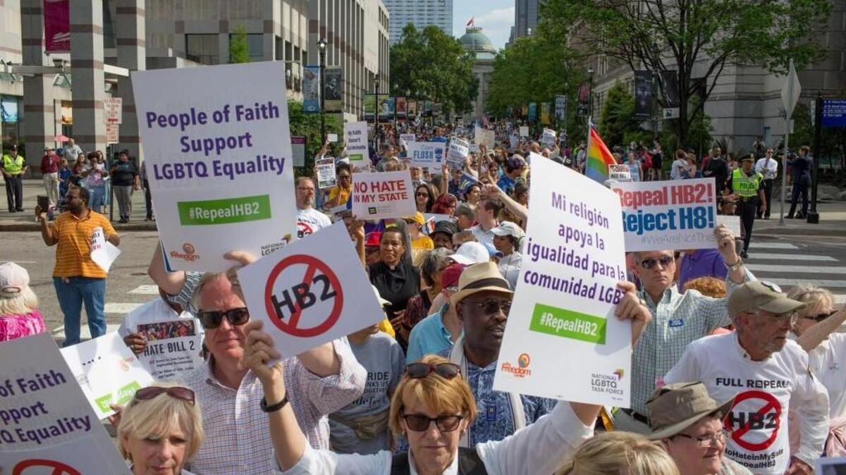 Moral Monday demonstrators head toward the General Assembly from the Bicentennial Mall after gathering and calling for the repeal of HB2 in Raleigh