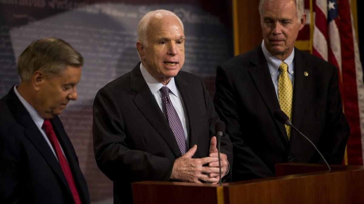 Sen. John McCain (R-Ariz.) speaks to reporters at a news conference on health care at the Capitol in Washington, July 27, 2017. McCain is among four Republican senators who declared Thursday that they would not vote for a slimmed-down partial repeal of the Affordable Care Act without guarantees that the House will negotiate a comprehensive measure. From left: Sens. Lindsey Graham (R-S.C.), McCain and Ron Johnson (R-Wis.).