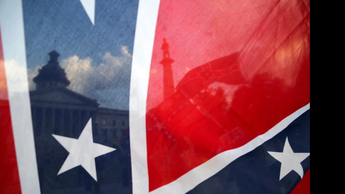 
The South Carolina State House is seen through a Confederate flag.
