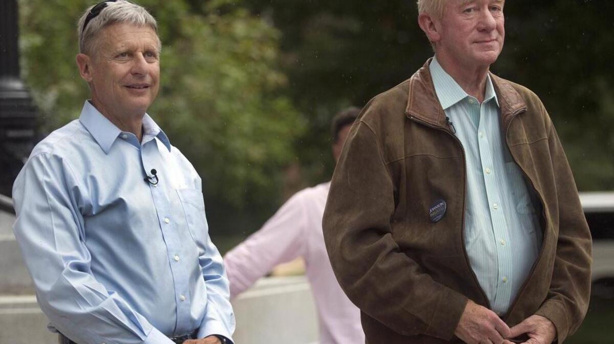 Former New Mexico governor, Libertarian presidential candidate Gary Johnson, left, stands with his vice presidential running mate, former Massachusetts governor William Weld during a campaign stop Aug. 25 in Concord, N.H.