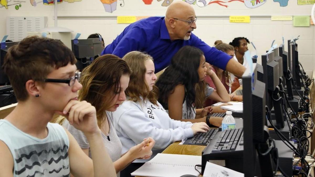 Credit recovery class instructor Mike Bellissimo, standing, helps students, grades 9-12 focus their online studies during the second half of their computer lab at Sanderson High School, Raleigh, NC Thursday, September 1, 2016. Currently, a legislative committee of the General Assembly is considering changes to the public school funding formula.