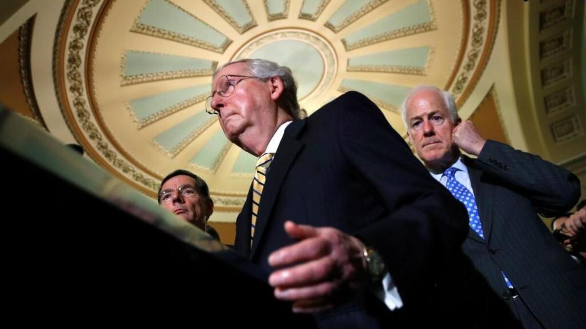 Senate Majority Leader Mitch McConnell of Ky., center, with Senate Majority Whip Sen. John Cornyn, R-Texas, right, and Sen. John Barrasso, R-Wyo., left, talks to reporters on Capitol Hill in Washington, Tuesday, July 25, 2017, after Vice President Mike Pence broke a 50-50 tie to start debating Republican legislation to tear down much of the Obama health care law.