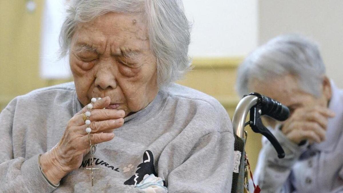 Atomic bomb survivor Kimiko Moriyama, 97, prays at the Megumi no Oka nursing home for atomic bomb survivors in Nagasaki.