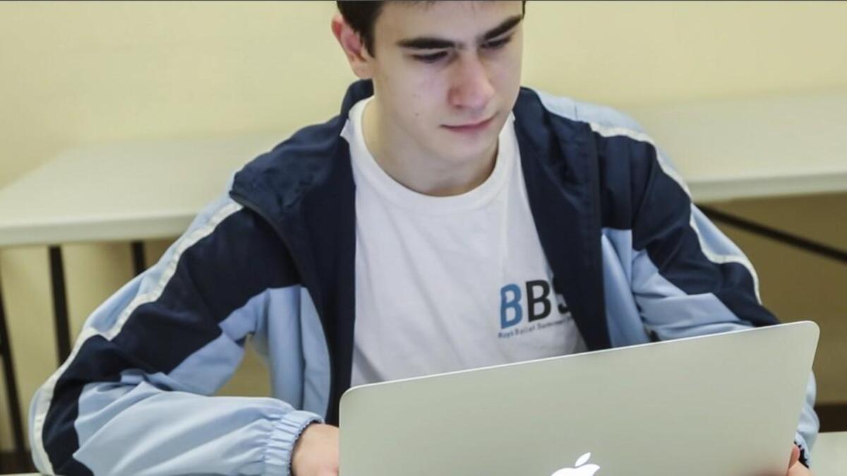 A student does schoolwork online after participating in an advanced dance program at the International Ballet Academy in Cary.