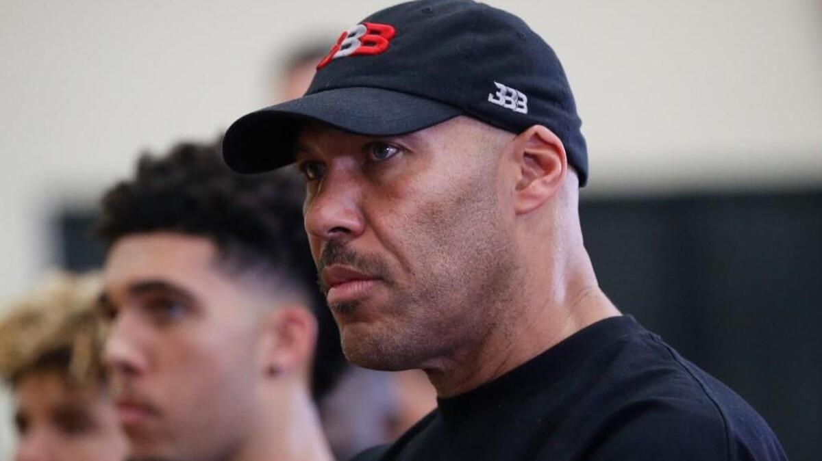 LaVar Ball, center, father of Los Angeles Lakers draft pick Lonzo Ball, listens to his son during a news conference, Friday, June 23, 2017, in El Segundo, Calif.