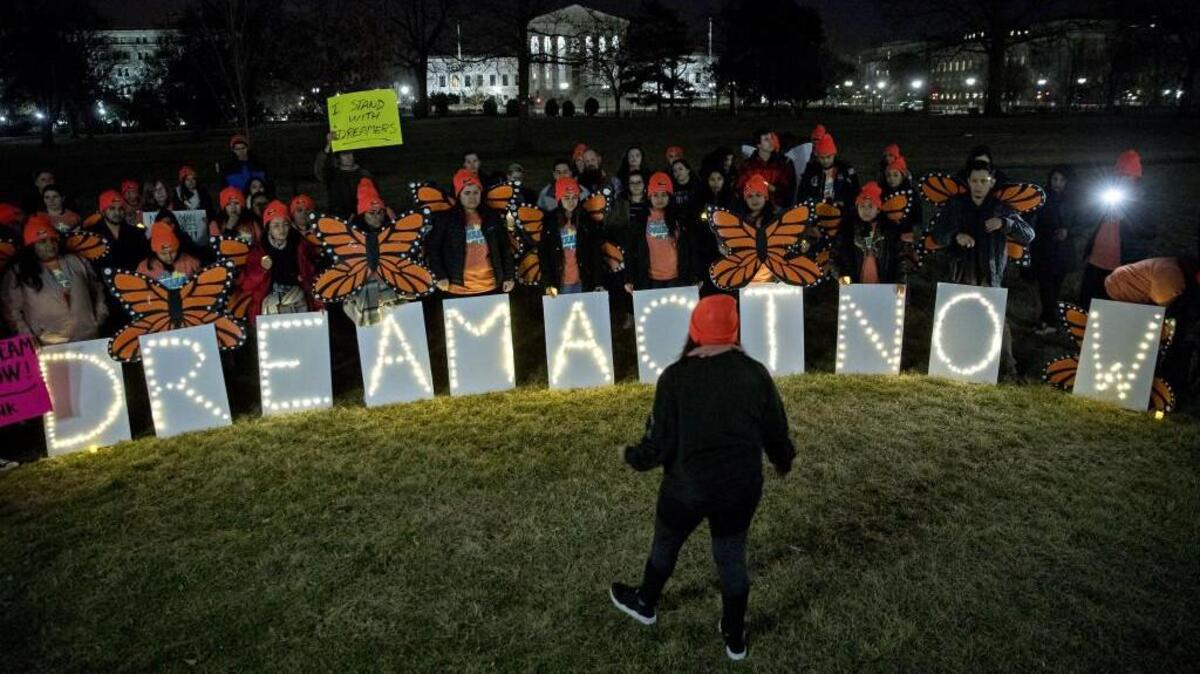 Demonstrators hold illuminated signs during a rally supporting the Deferred Action for Childhood Arrivals program (DACA), or the Dream Act, outside the Capitol on Sunday.