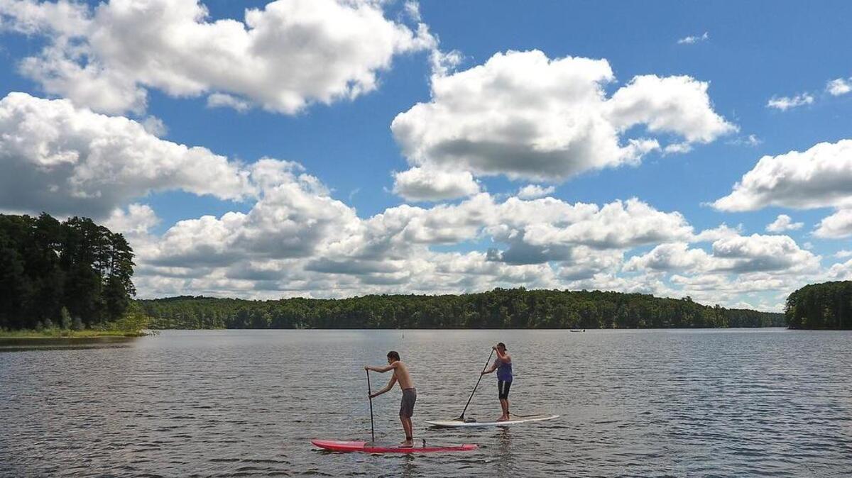 Bryce, left, and Jason Tuton of Raleigh paddle across Falls Lake in 2016. The lake supplies Raleigh’s drinking water. Two advocates for protecting the Falls Lake watershed say a zoning proposal before the Raleigh Planning Commission on March 12, 2024 could harm the watershed.