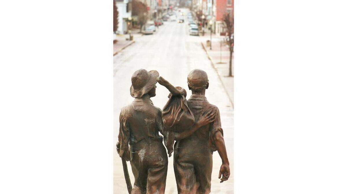 A bronze statue depicting Tom Sawyer and Huckleberry Finn heading off for another adventure stands at the north end of Main Street in the childhood hometown of Mark Twain in downtown Hannibal, Mo.