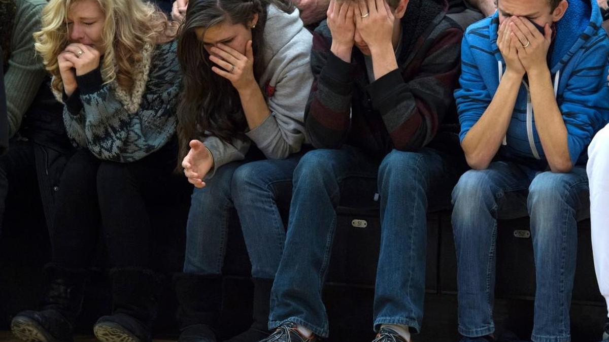Shyanne Bryant, Makayla Bryant, Keaton Dontanville and Caiden Dontanville attend a vigil held on the University of Colorado-Colorado Springs’ campus for those killed in the deadly shooting at a Planned Parenthood clinic.