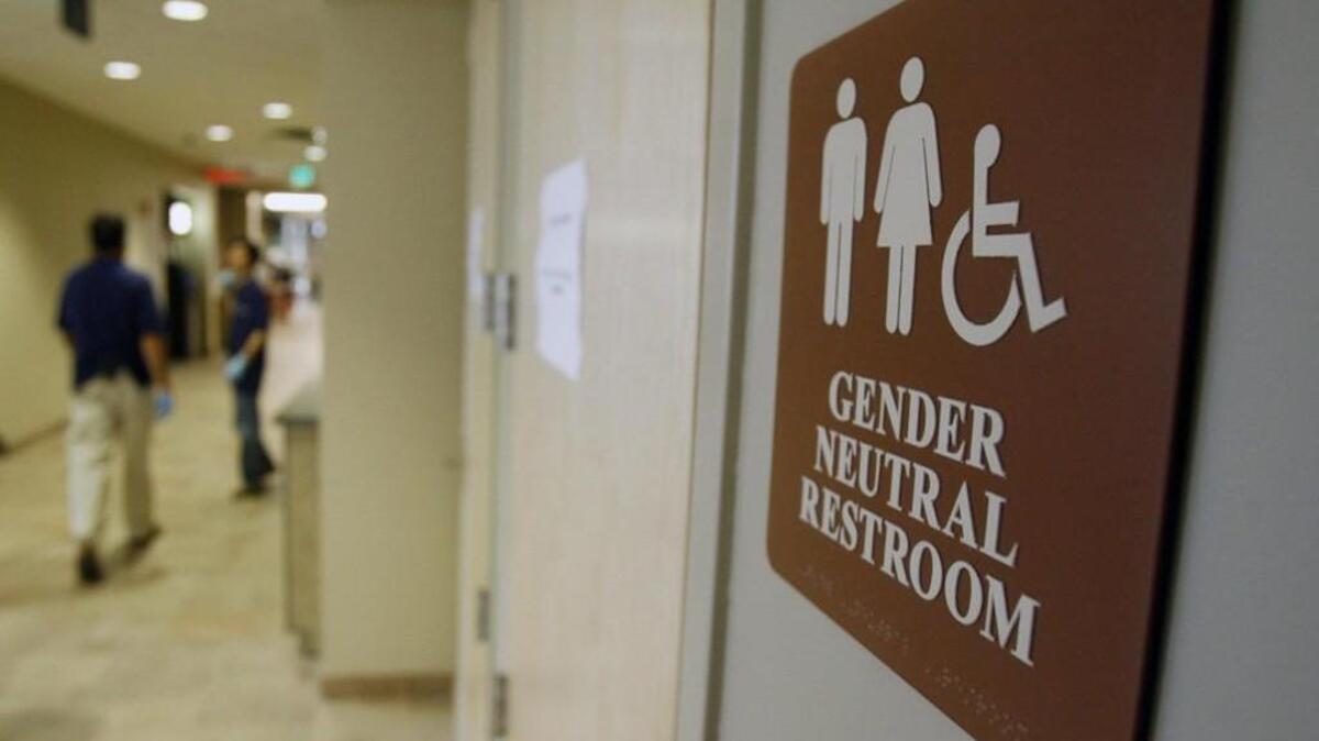 FILE- In this Aug. 23, 2007, file photo, a sign marks the entrance to a gender-neutral restroom at the University of Vermont in Burlington, Vt. Nearly all of the nation's 20 largest cities, including New York City, have local or state nondiscrimination laws that allow transgender people to use whatever bathroom they identify with, though a debate has raged around the topic nationwide. (AP Photo/Toby Talbot, File)
