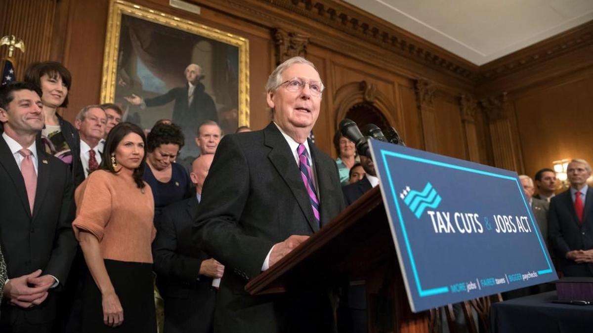 Senate Majority Leader Mitch McConnell, R-Ky., joined at left by Speaker of the House Paul Ryan, R-Wis., praises the Republican tax plan during an enrollment ceremony at the Capitol in Washington, Thursday, Dec. 21, 2017.