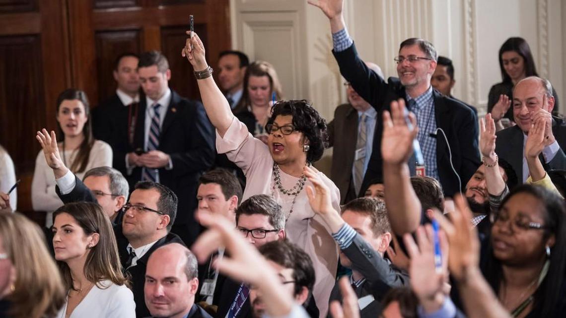 Reporters and members of the media raise their hands for questions as President Donald Trump speaks during a press conference in the East Room of the White House on Thursday.