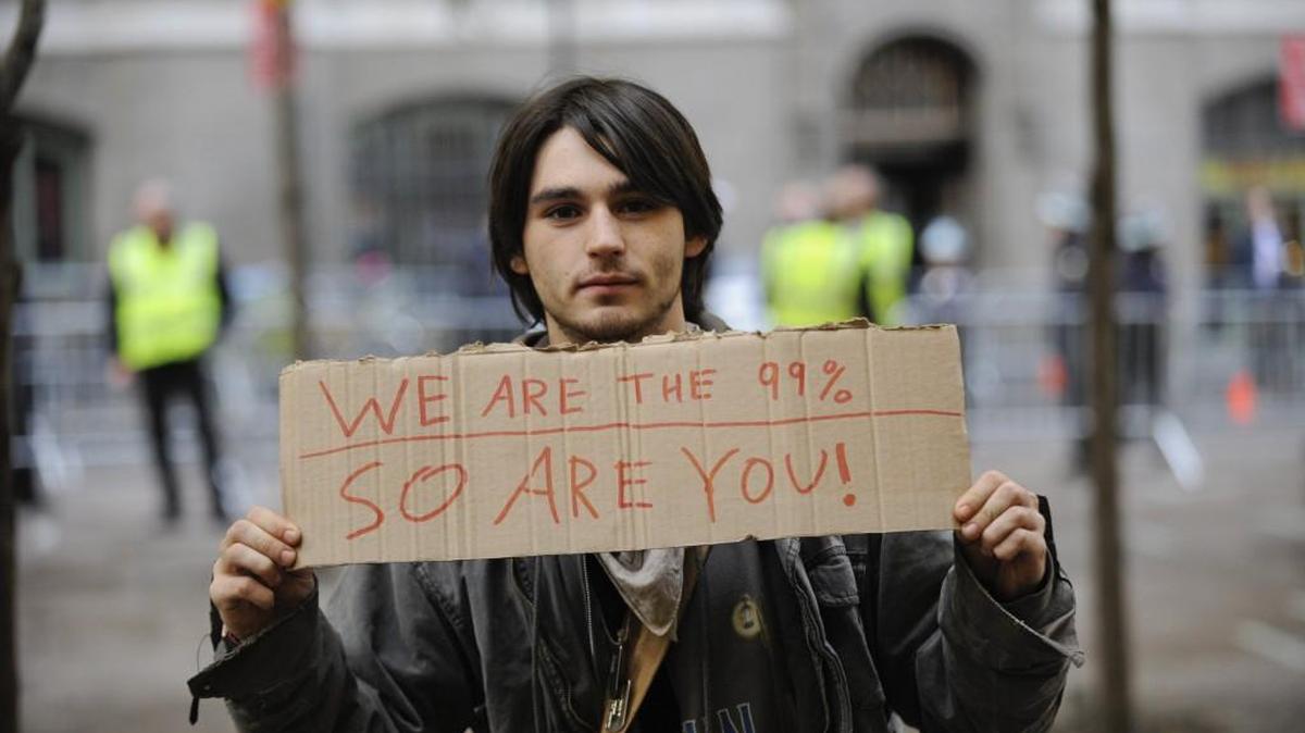 A demonstrator with the Occupy Wall Street movement holds a sign near Zuccotti Park in New York, Nov. 15, 2011. The gap between the ultrarich and the middle class is no longer just a rallying cry to incite anticapitalist advocates, but instead the issue has become mainstream, debated in arenas where the primacy of laissez-faire capitalism once was taken for granted.