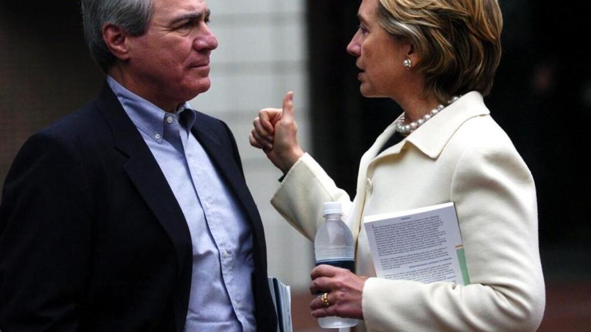 Hillary Clinton talks to Phil Lader, co-founder of the Renaissance Weekend, outside of the Charleston Place Hotel in Charleston, S.C., in 2004.